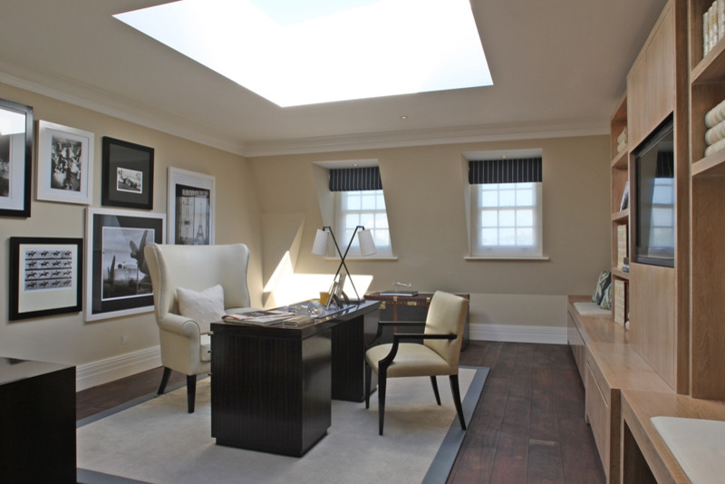 Inspiration for a large contemporary study in London with beige walls, dark hardwood flooring and a freestanding desk.