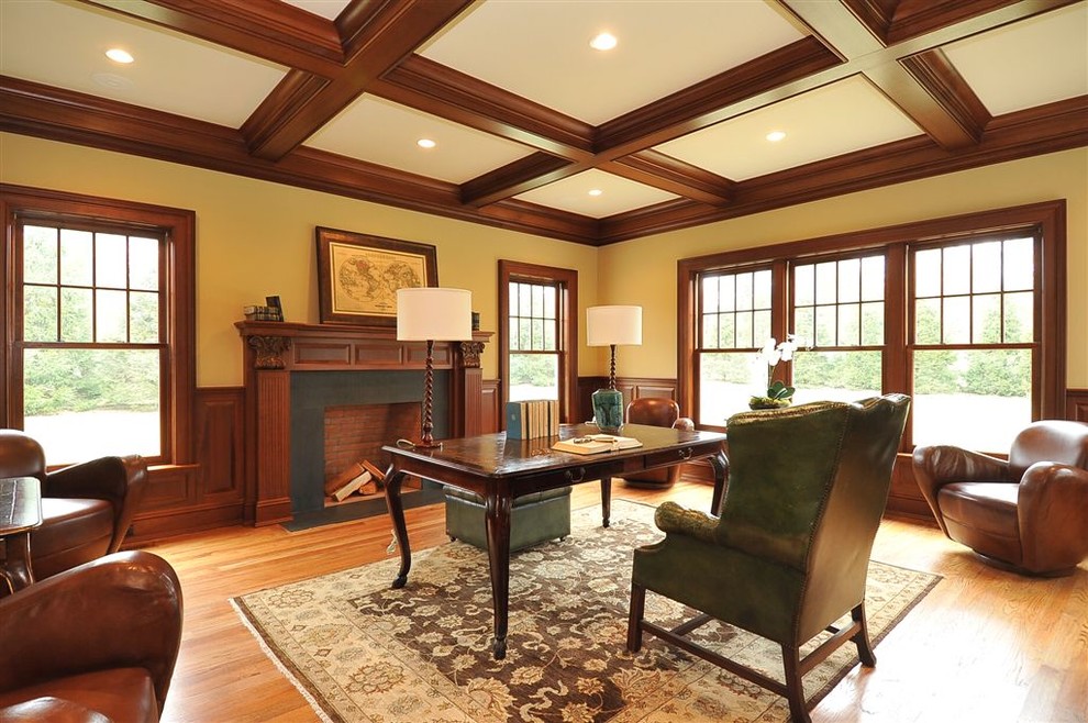 Medium sized traditional home office in New York with light hardwood flooring, a standard fireplace, a stone fireplace surround, a freestanding desk and a dado rail.