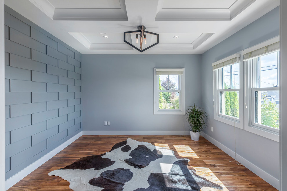 Large transitional medium tone wood floor and brown floor study room photo in Vancouver with gray walls