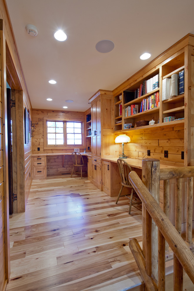 Study room - mid-sized rustic built-in desk medium tone wood floor study room idea in Other with brown walls