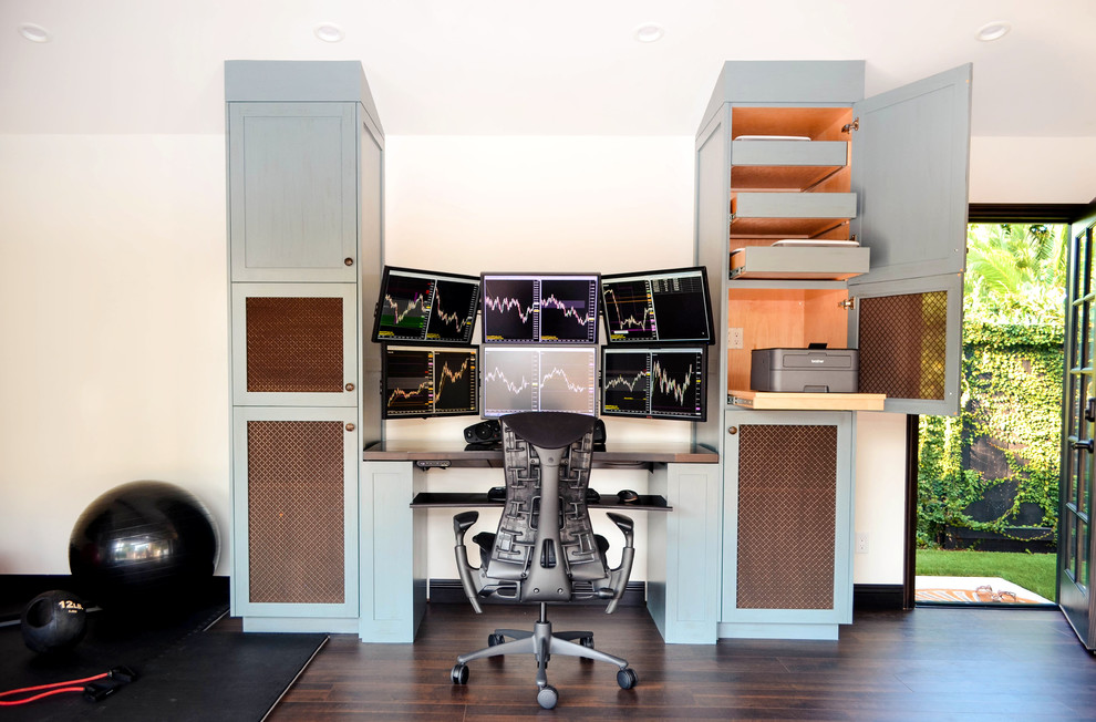 Home studio - mid-sized mediterranean built-in desk laminate floor and brown floor home studio idea in Los Angeles with white walls and no fireplace
