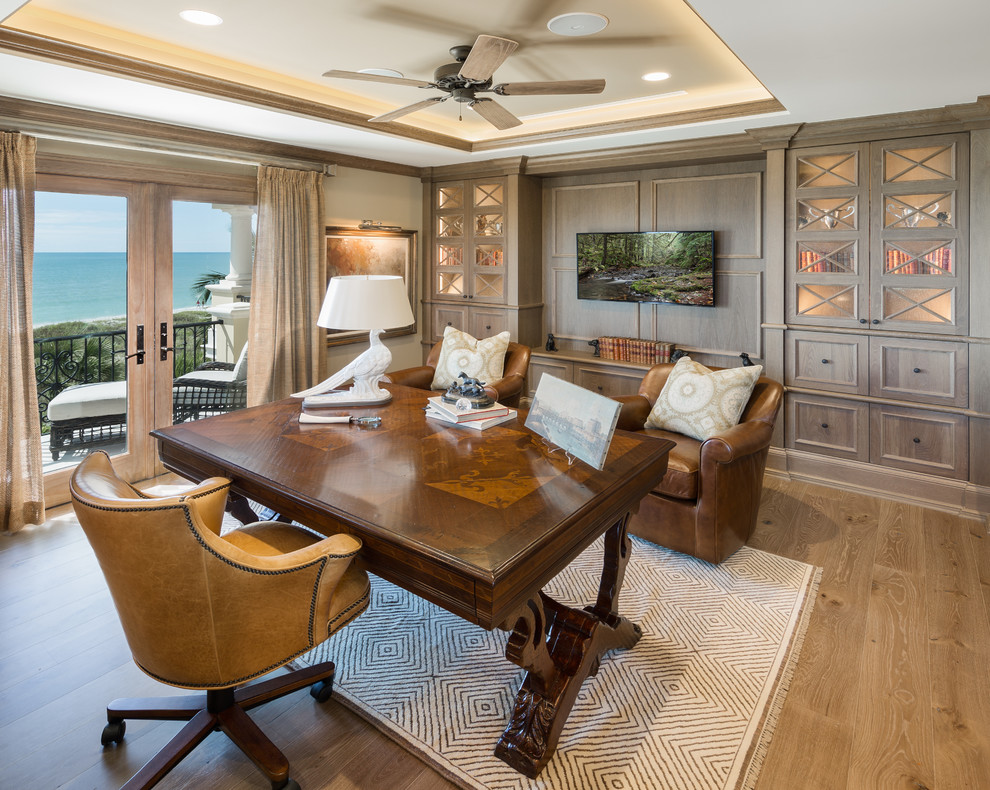 Study room - huge traditional freestanding desk medium tone wood floor study room idea in Tampa with gray walls