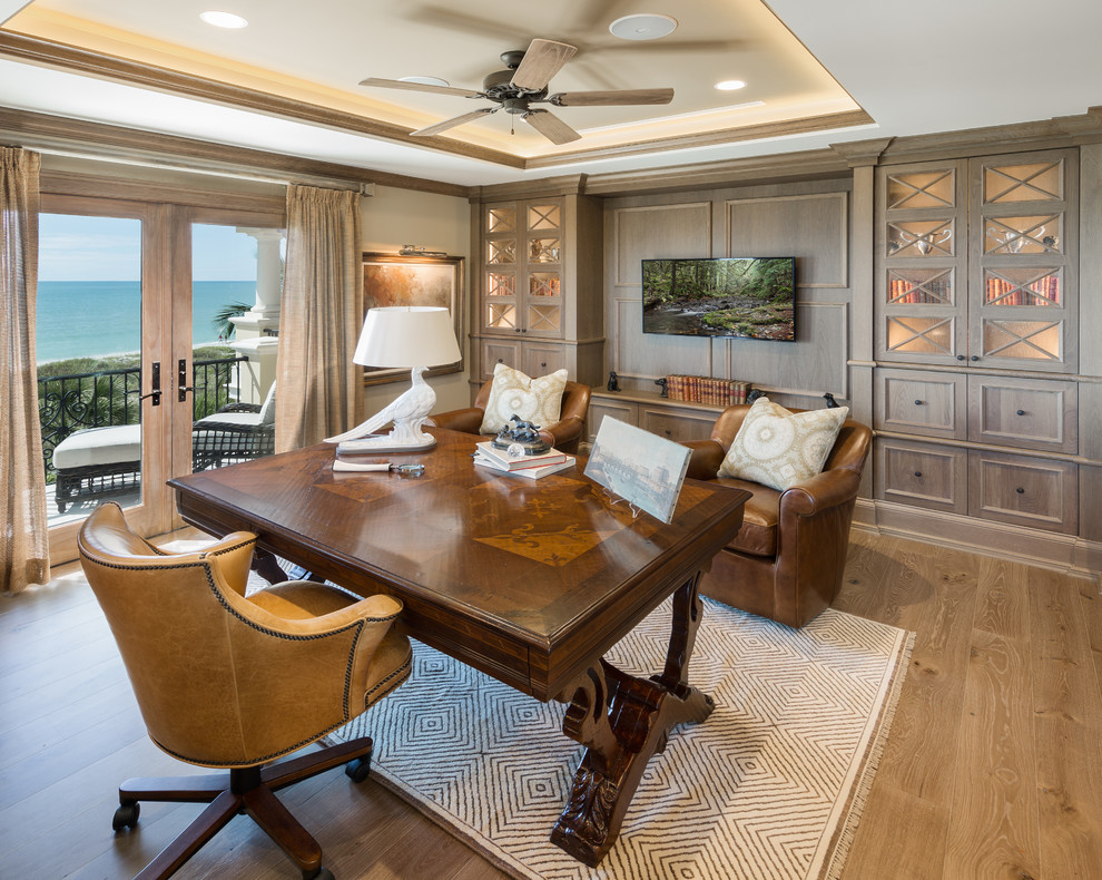 Photo of an expansive traditional study in Tampa with grey walls, medium hardwood flooring and a freestanding desk.