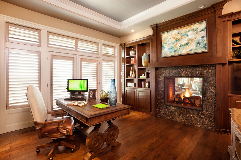 Design ideas for a classic study in Portland with beige walls, medium hardwood flooring, a standard fireplace and a freestanding desk.