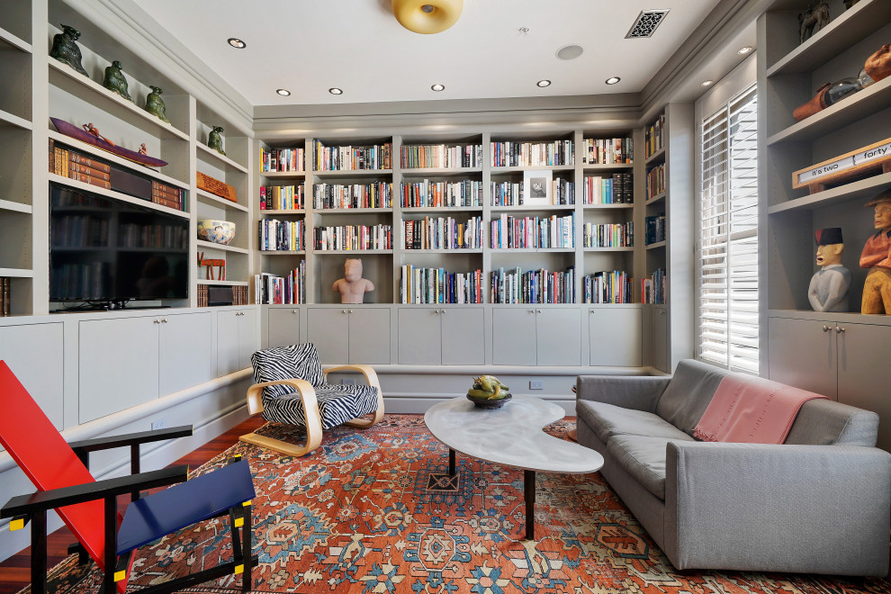 This is an example of a large eclectic home office in San Francisco with a reading nook, grey walls, medium hardwood flooring and no fireplace.