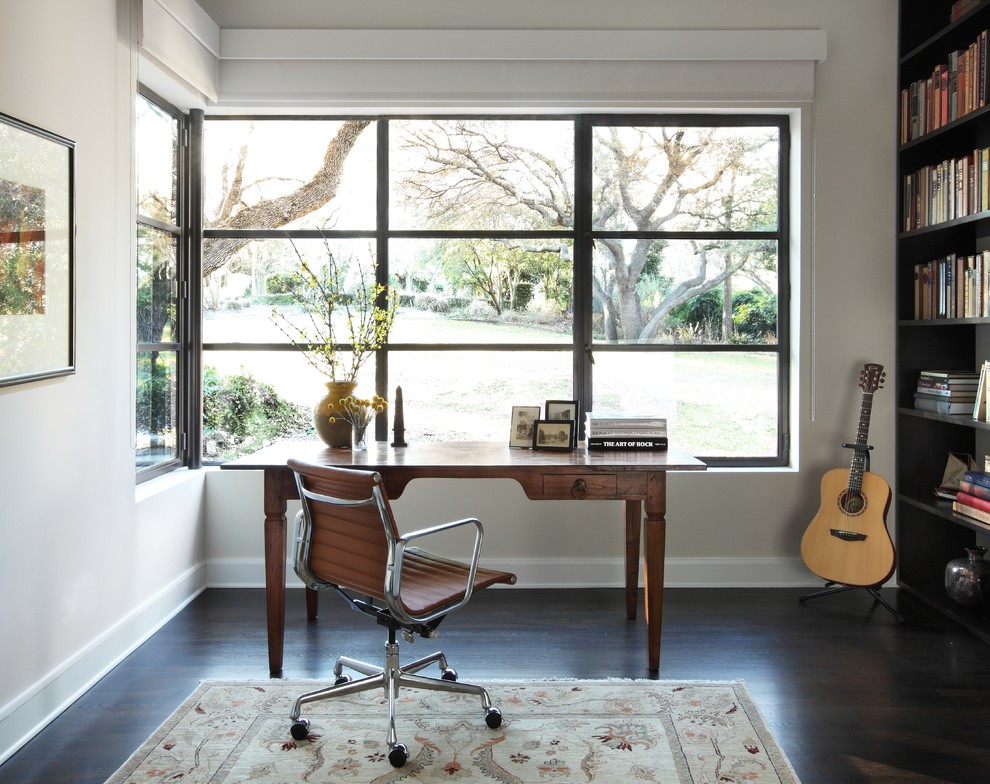 Home office - contemporary freestanding desk dark wood floor and brown floor home office idea in Austin with white walls