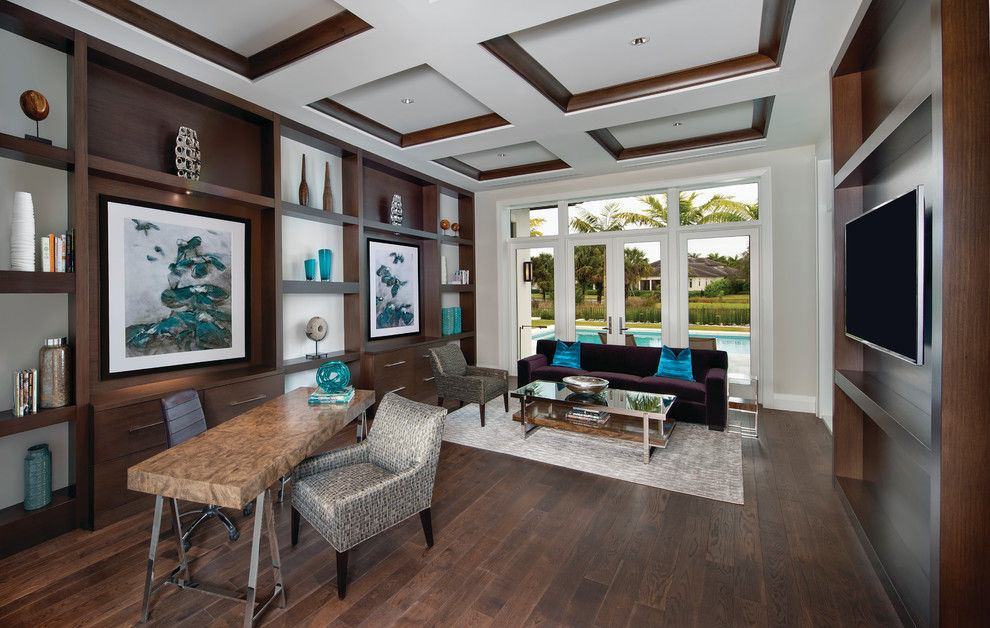 Photo of a traditional study in Miami with dark hardwood flooring, a freestanding desk and white walls.