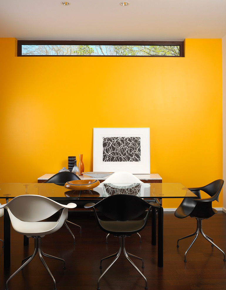 Ejemplo de despacho actual sin chimenea con paredes amarillas y escritorio independiente