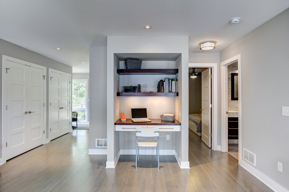 Study room - small transitional built-in desk medium tone wood floor study room idea in Minneapolis with gray walls