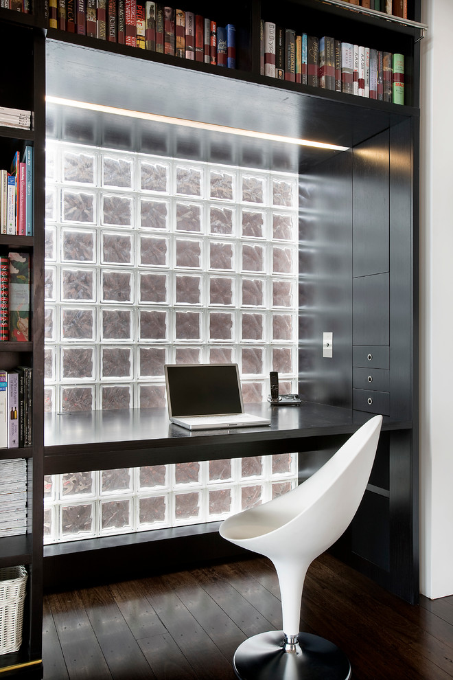 This is an example of a small contemporary home office in Sydney with a built-in desk.