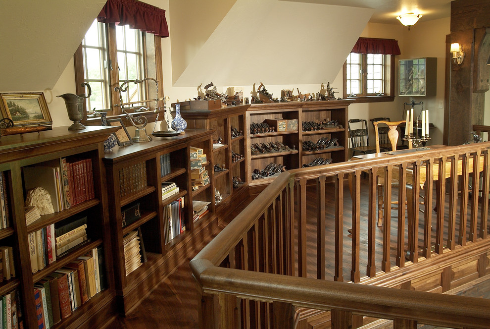 This is an example of a classic home office in Minneapolis with beige walls, dark hardwood flooring and a freestanding desk.