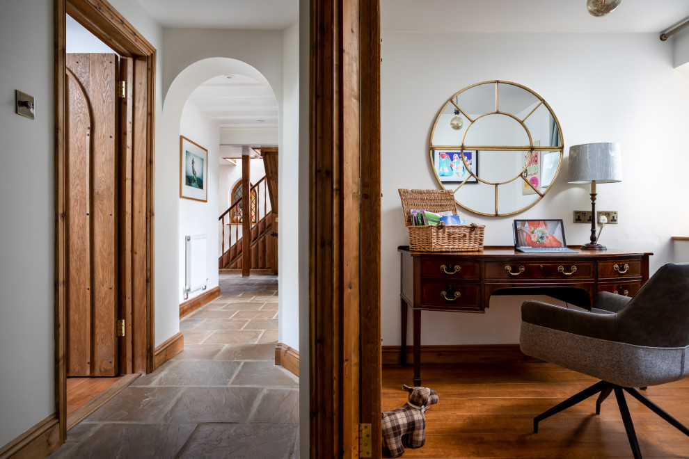 Small traditional study in Gloucestershire with white walls, dark hardwood flooring and a freestanding desk.