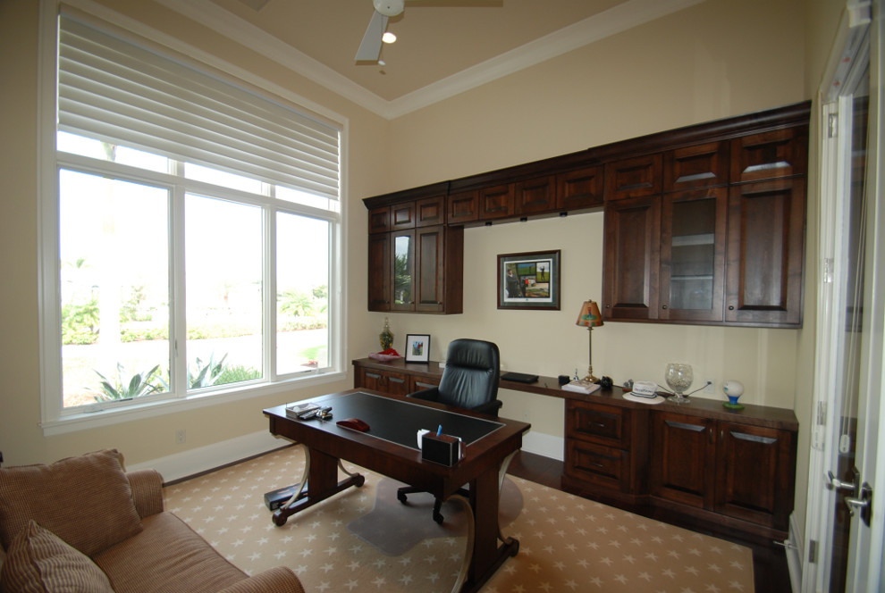 Inspiration for a medium sized mediterranean home office in Miami with beige walls, carpet and a freestanding desk.