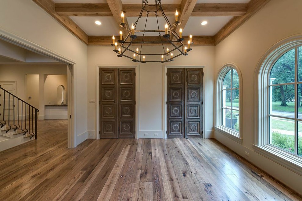 Example of a large tuscan freestanding desk medium tone wood floor study room design in Houston with beige walls
