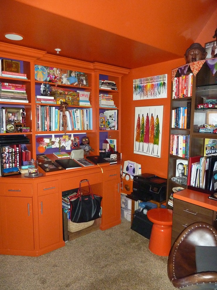 Inspiration for a small eclectic home office in San Francisco with orange walls and a freestanding desk.