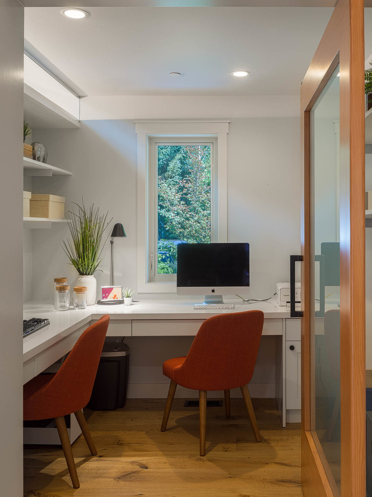 Mid-sized transitional built-in desk medium tone wood floor and brown floor study room photo in Seattle with gray walls