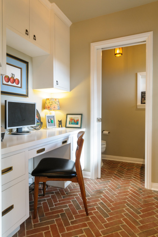 Photo of a small world-inspired home office in Los Angeles with beige walls, brick flooring and a built-in desk.