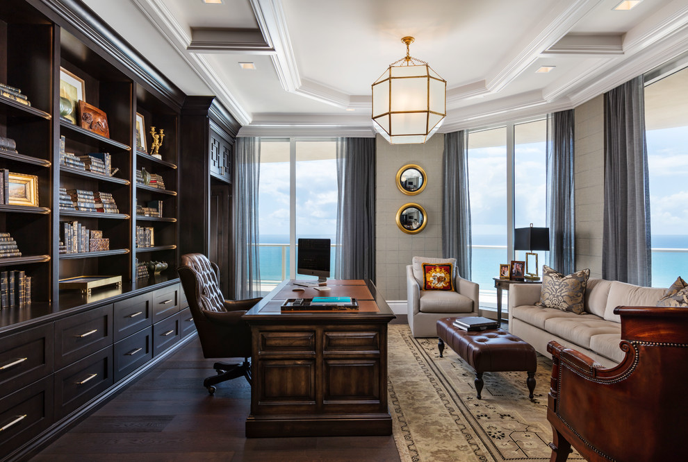 Photo of a traditional study in Miami with grey walls, dark hardwood flooring, a freestanding desk and brown floors.