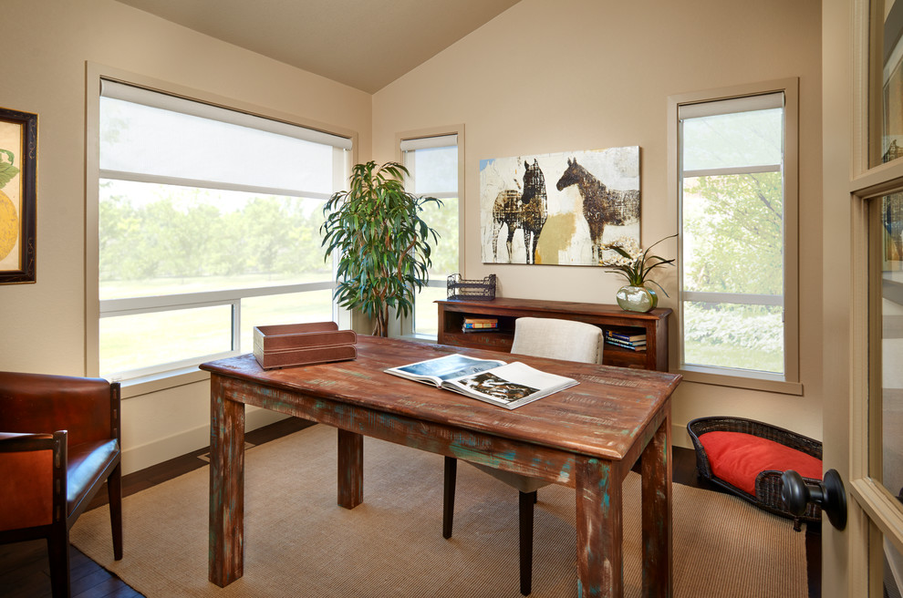 This is an example of a contemporary home office in Denver with beige walls, dark hardwood flooring and a freestanding desk.