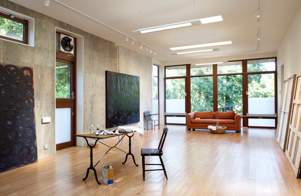 Home studio - mid-sized modern medium tone wood floor home studio idea in San Francisco with white walls