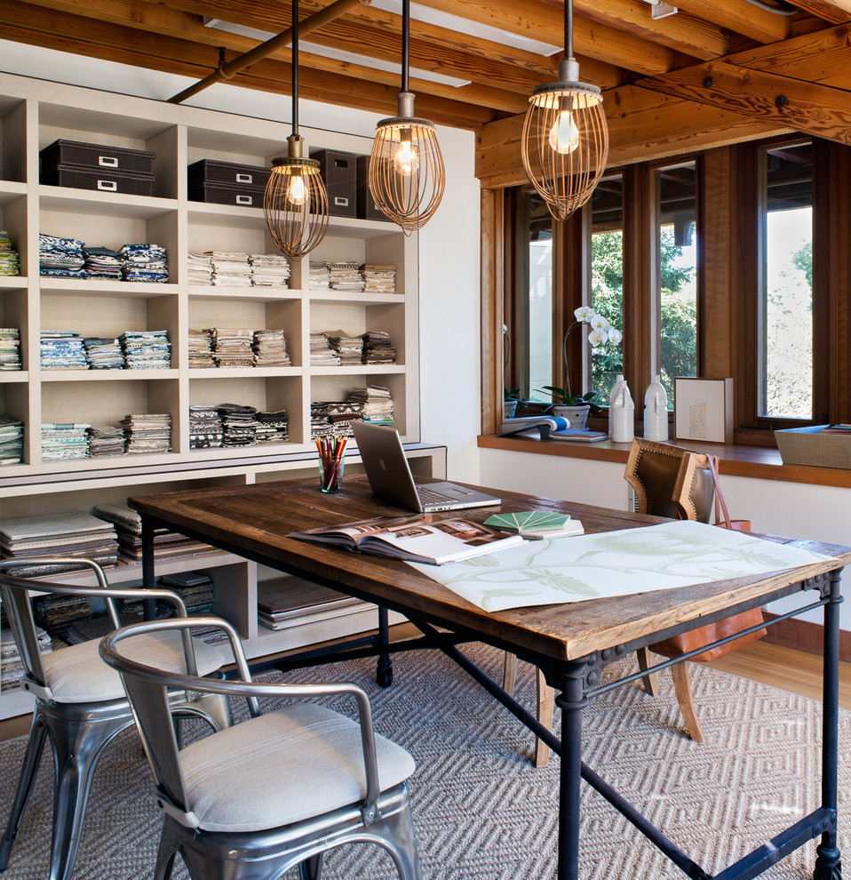 Trendy freestanding desk medium tone wood floor home studio photo in San Francisco with white walls
