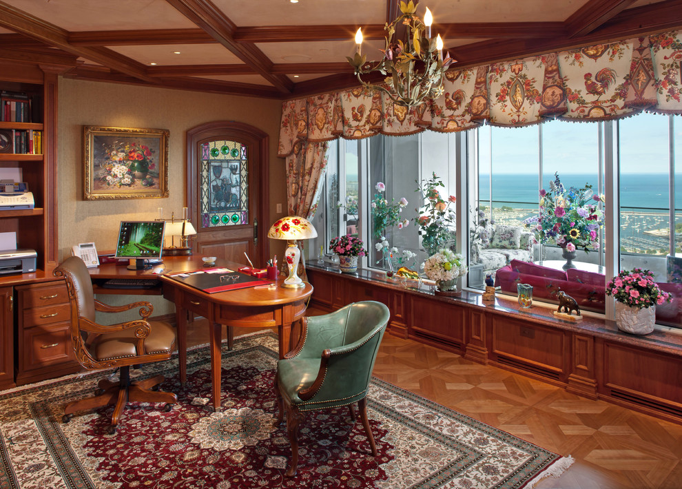 Tuscan freestanding desk medium tone wood floor home office photo in Milwaukee