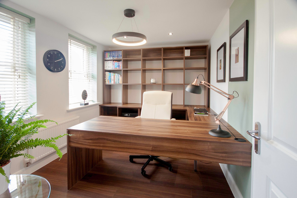 Example of a mid-sized classic dark wood floor study room design in Buckinghamshire with white walls