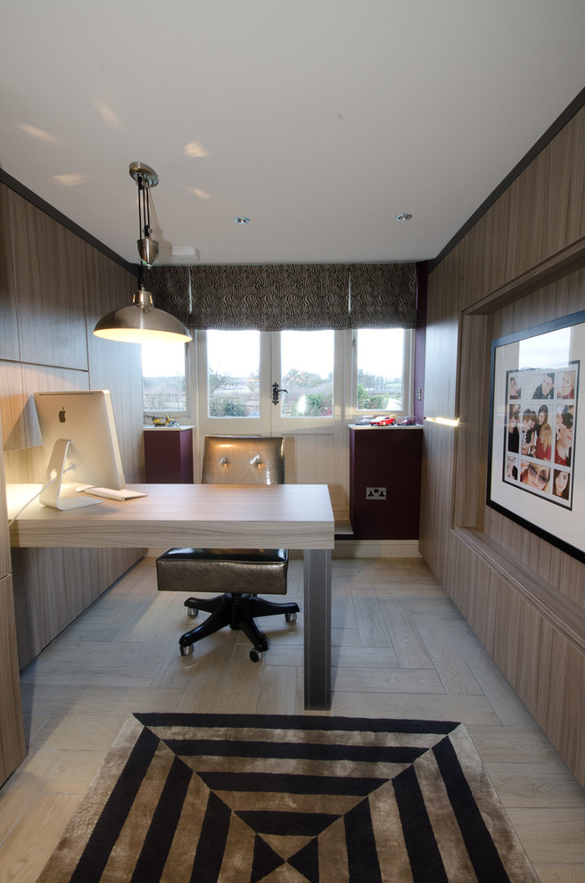 This is an example of a large contemporary study in West Midlands with ceramic flooring and a built-in desk.