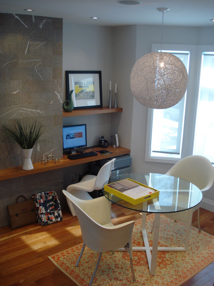 Home office - modern medium tone wood floor home office idea in Toronto with gray walls