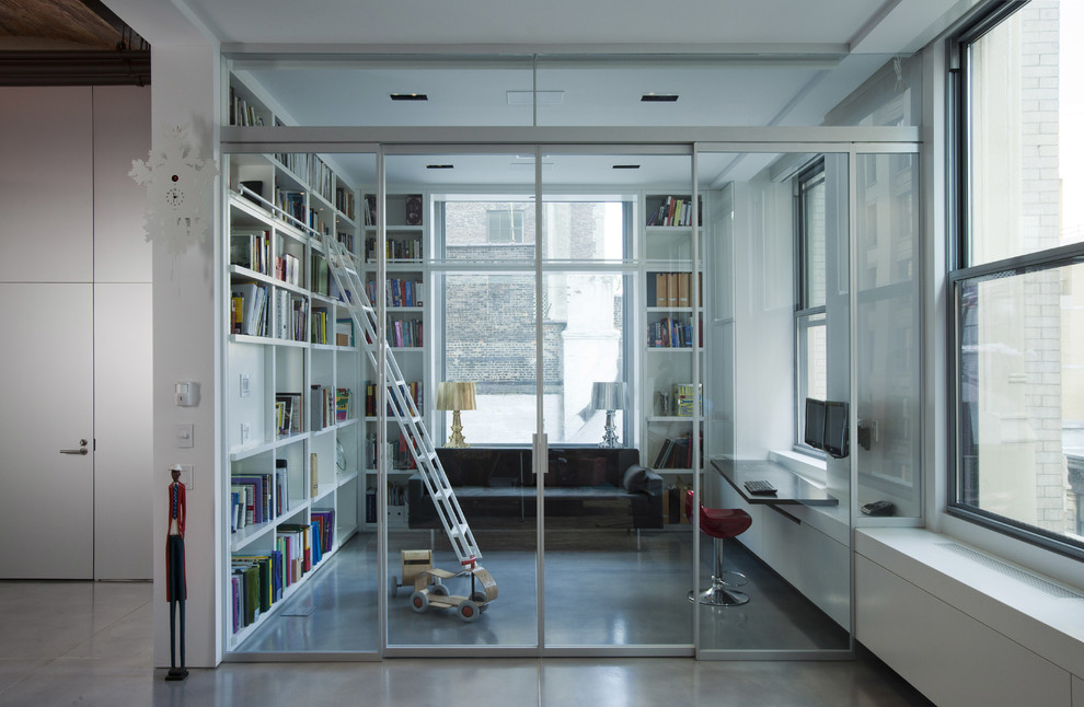 Example of an urban concrete floor home office design in New York