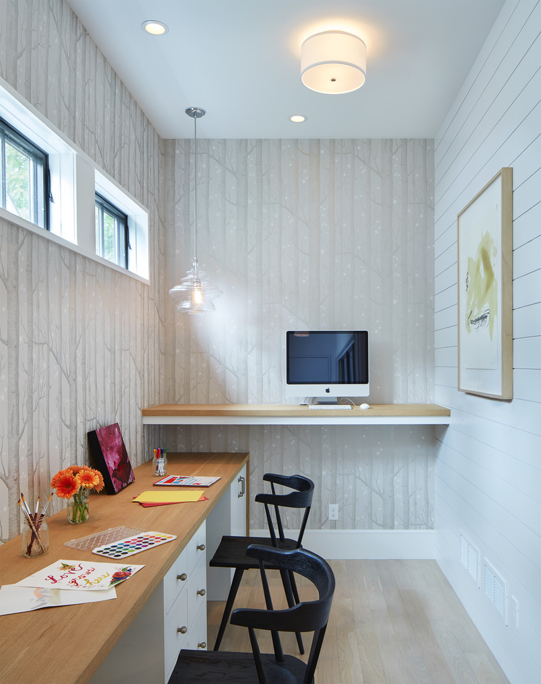 Traditional home office in Minneapolis with grey walls, light hardwood flooring, a built-in desk and beige floors.