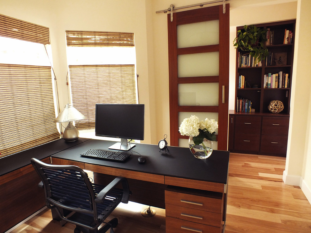Example of a mid-sized trendy freestanding desk light wood floor home office design in Los Angeles with yellow walls and no fireplace