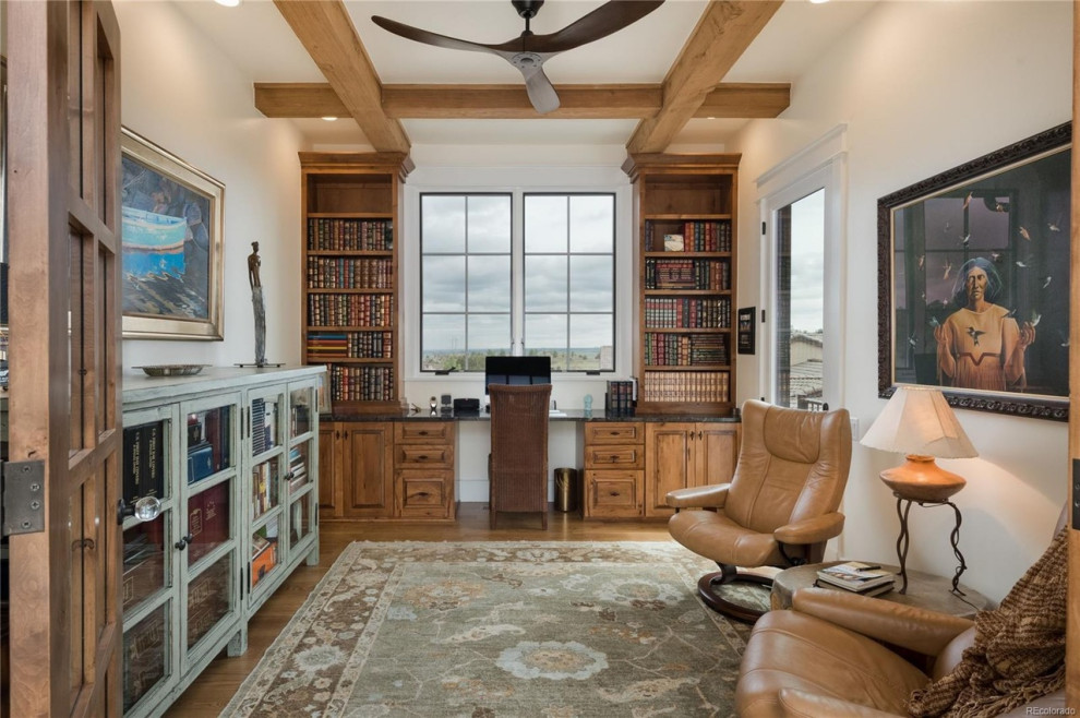 Design ideas for a home office in Denver with white walls, light hardwood flooring, a built-in desk and exposed beams.