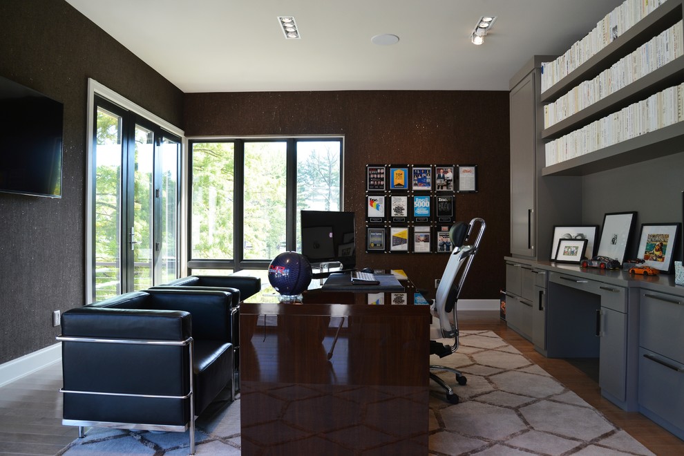 Inspiration for a large contemporary freestanding desk light wood floor home office remodel in St Louis with brown walls