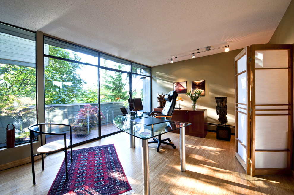 Large minimalist freestanding desk bamboo floor and beige floor study room photo in Vancouver with beige walls and no fireplace