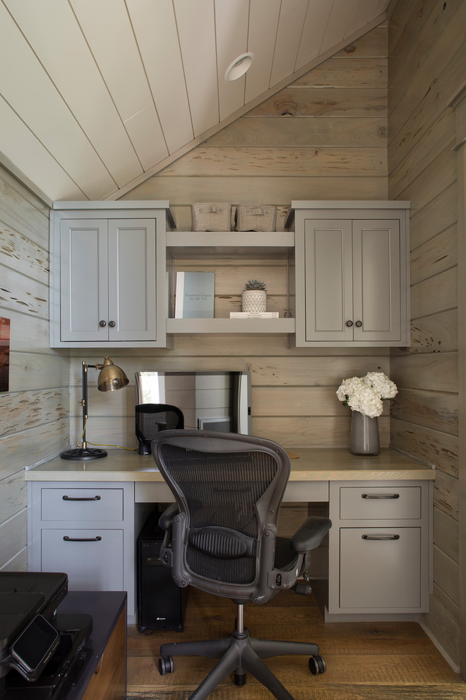 Home office - coastal built-in desk medium tone wood floor and brown floor home office idea in Other with beige walls