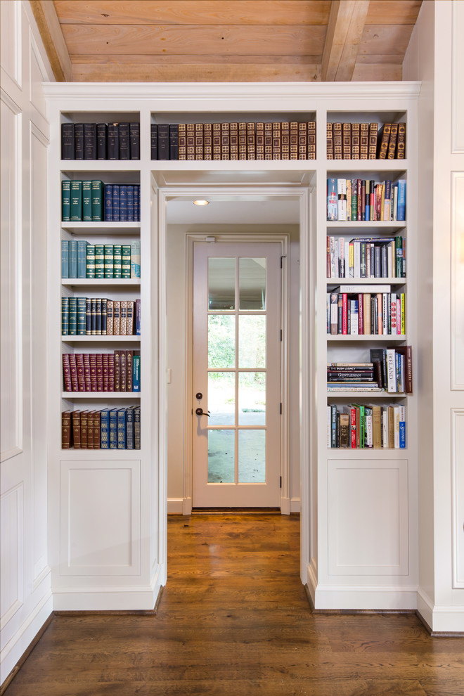 Пример оригинального дизайна: домашняя библиотека среднего размера в классическом стиле с белыми стенами, темным паркетным полом, отдельно стоящим рабочим столом и коричневым полом без камина