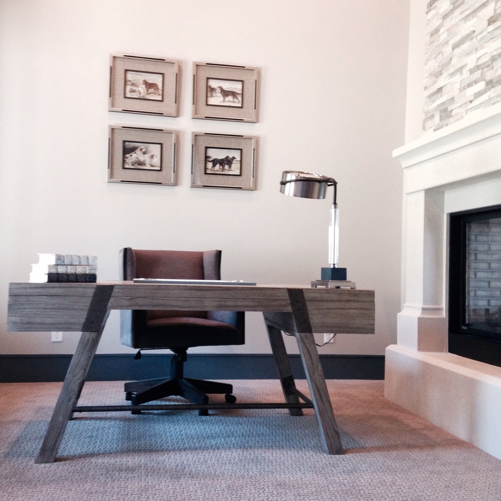 Medium sized study in Salt Lake City with white walls, carpet, a standard fireplace, a stone fireplace surround and a freestanding desk.