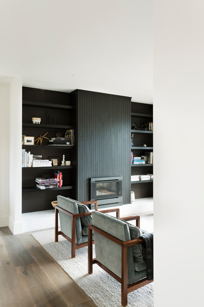 Study room - large scandinavian freestanding desk medium tone wood floor study room idea in Melbourne with white walls, a standard fireplace and a wood fireplace surround