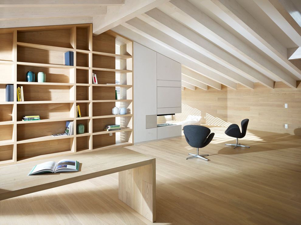 Contemporary home office in Other with light hardwood flooring.
