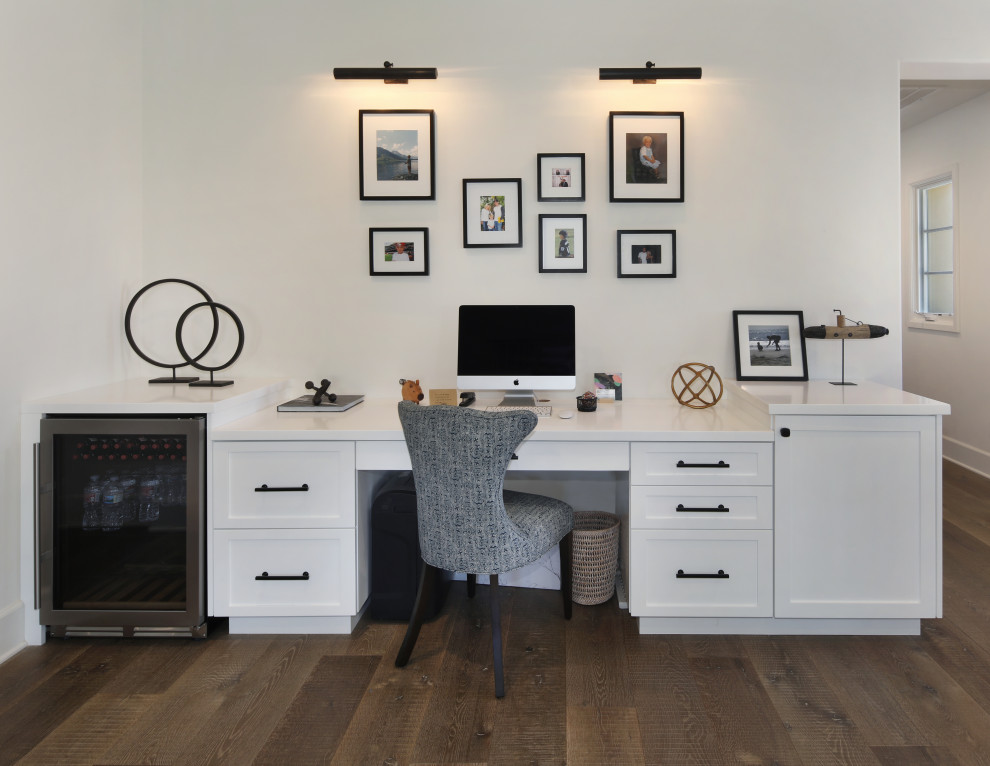 This is an example of a small traditional study in Orange County with white walls, medium hardwood flooring and a built-in desk.