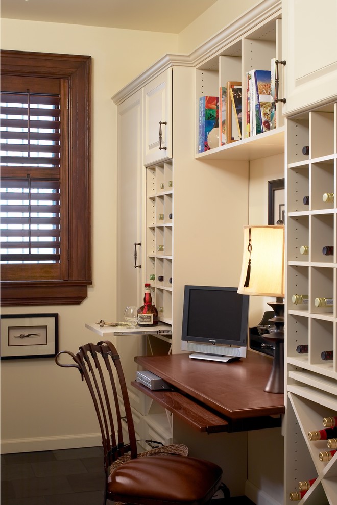 Inredning av ett klassiskt mellanstort arbetsrum, med vita väggar, skiffergolv och ett inbyggt skrivbord
