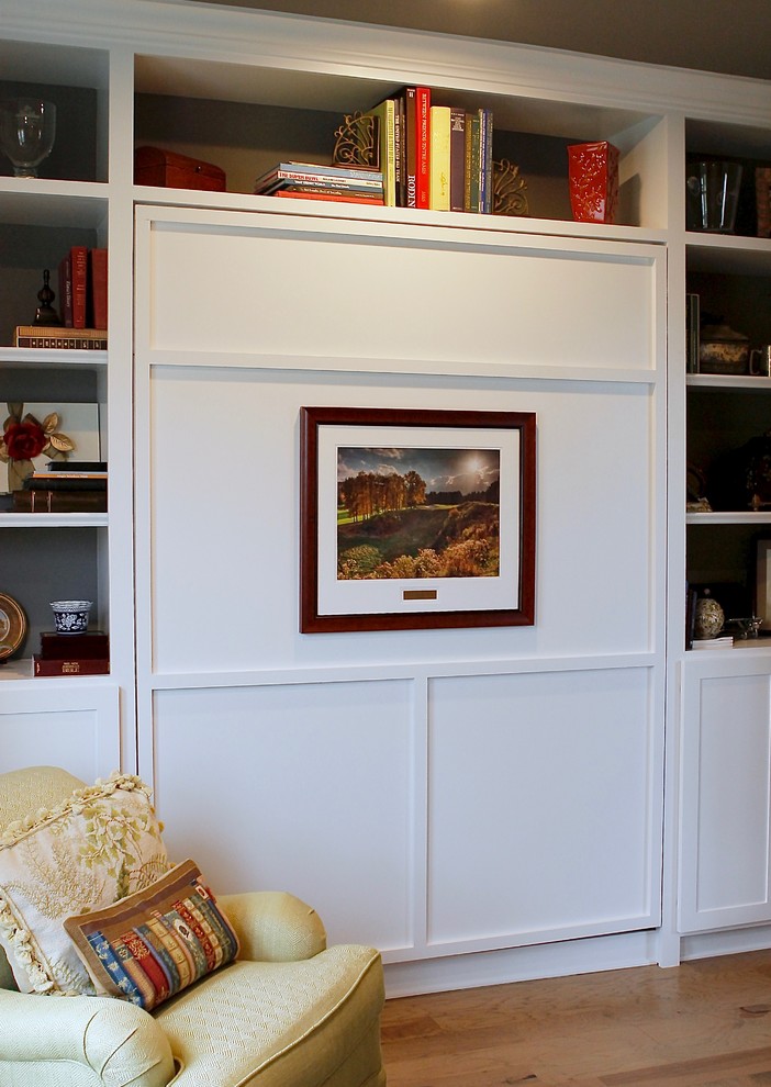 Ejemplo de despacho clásico de tamaño medio sin chimenea con paredes beige, suelo de madera clara, escritorio independiente y suelo marrón