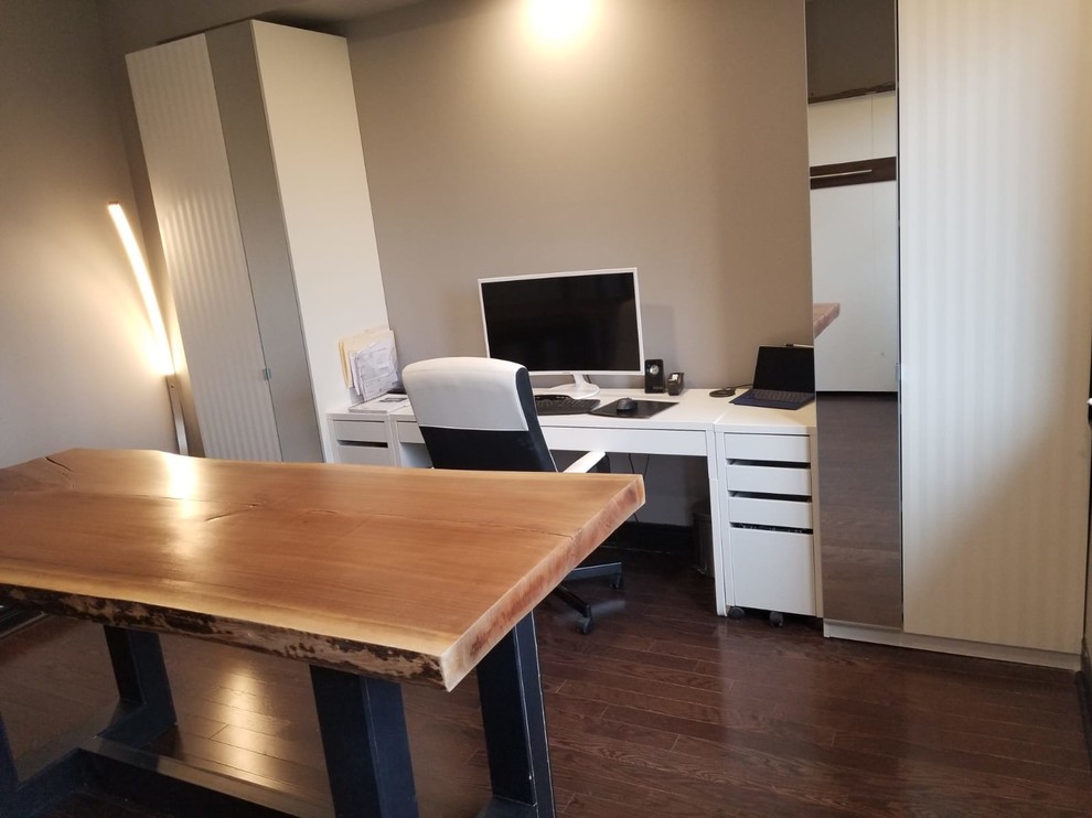 Example of a mid-sized transitional built-in desk medium tone wood floor and brown floor study room design in Toronto with gray walls and no fireplace