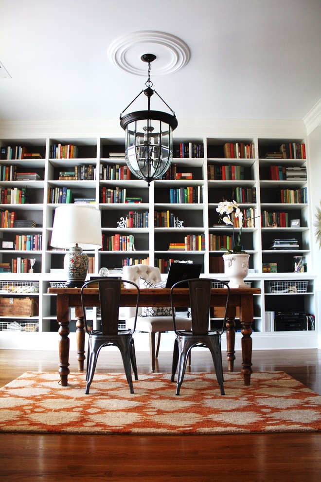 Example of an eclectic freestanding desk dark wood floor home office design in Charlotte with white walls