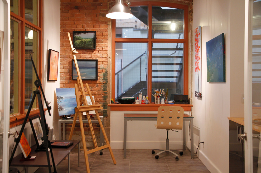 Inspiration for an industrial freestanding desk home studio remodel in Ottawa with white walls