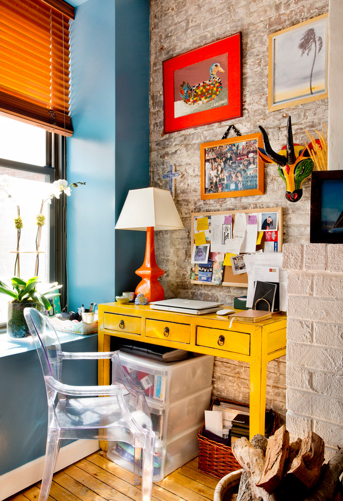 Study room - eclectic freestanding desk medium tone wood floor study room idea in New York