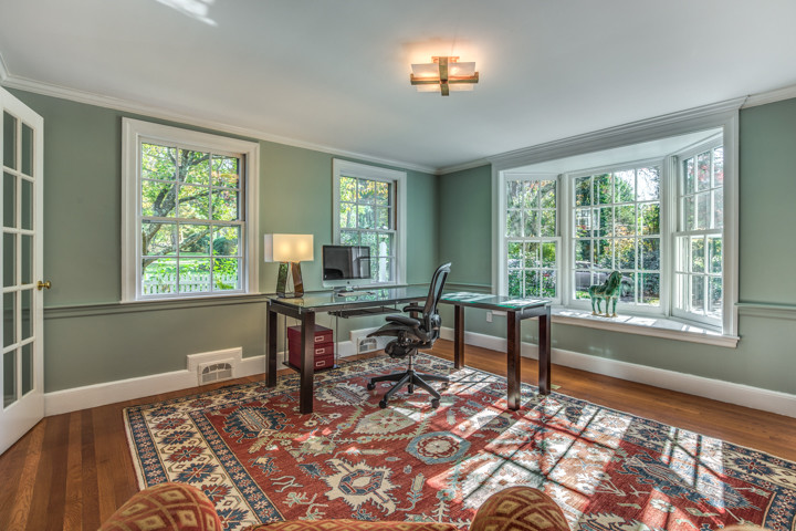 Large elegant freestanding desk medium tone wood floor study room photo in Boston with gray walls and no fireplace