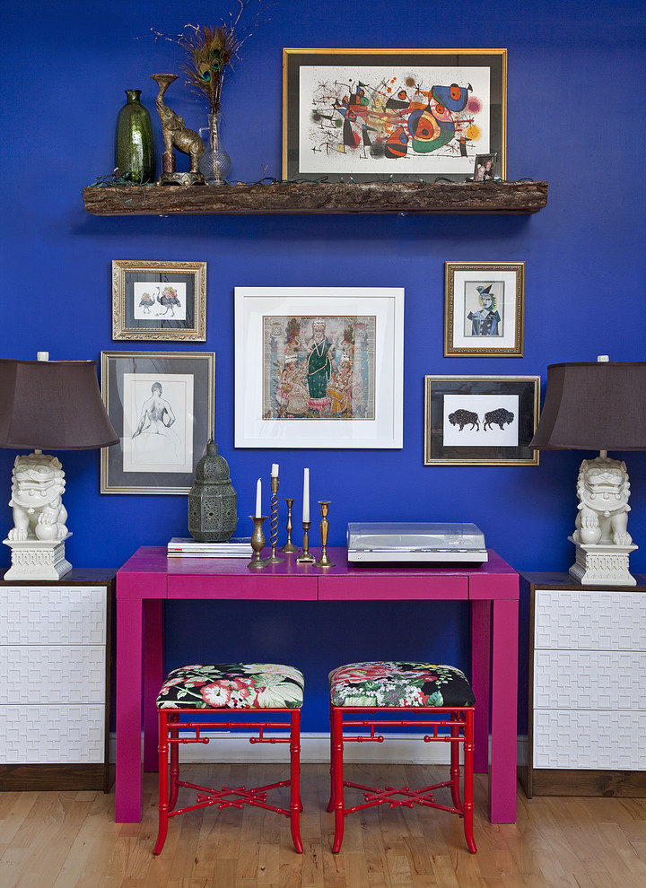 Diseño de despacho bohemio con paredes azules, suelo de madera en tonos medios y escritorio independiente