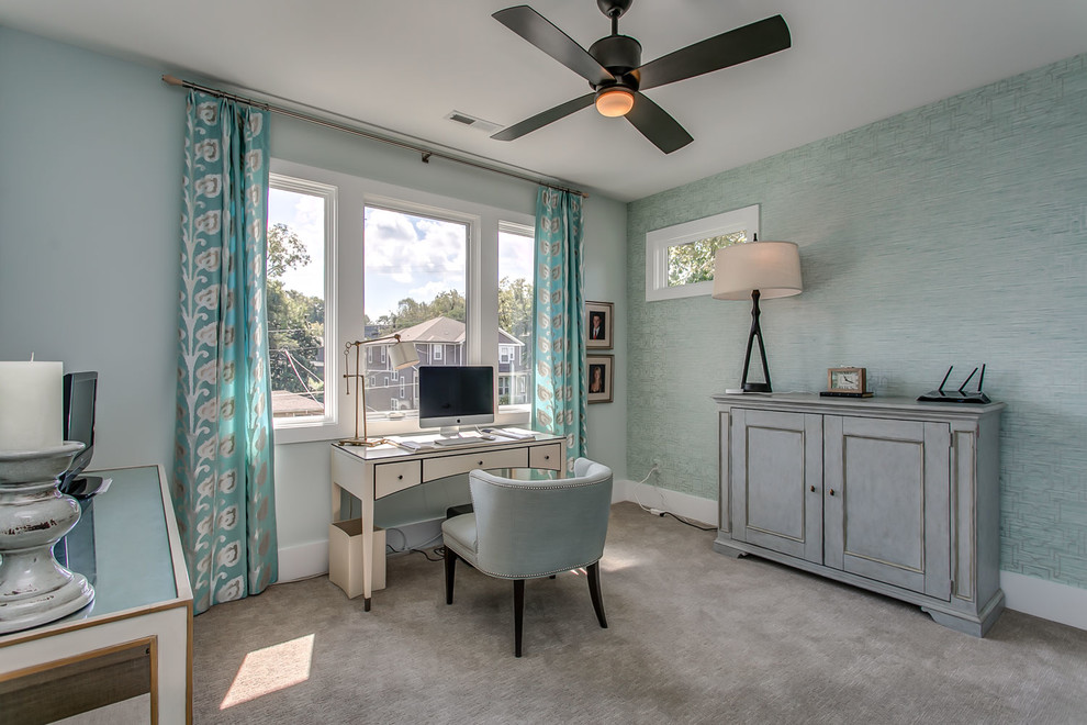 Photo of a traditional study in Orange County with blue walls, carpet, a freestanding desk and beige floors.